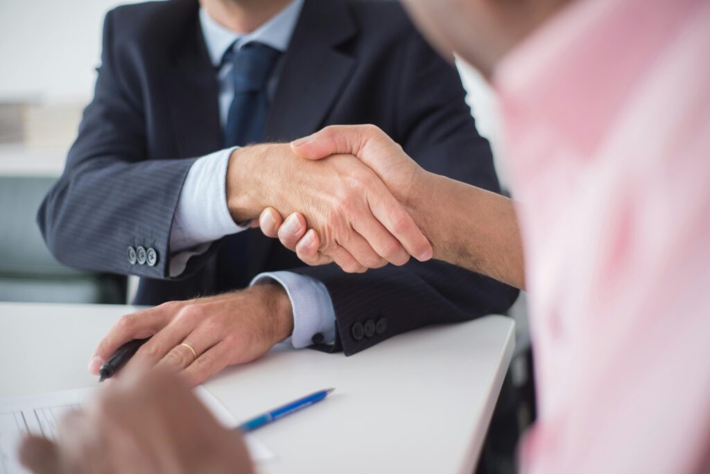 Business professionals shaking hands after successful agreement